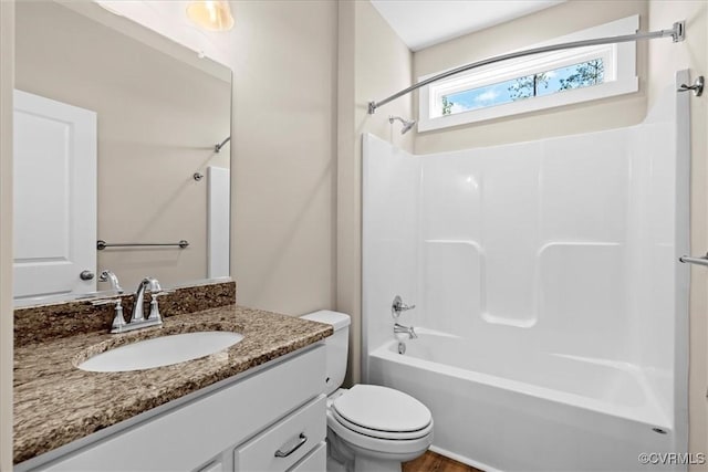 full bathroom featuring toilet, vanity, and shower / bathing tub combination