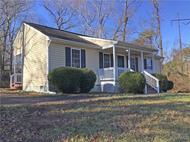 single story home with covered porch and a front lawn