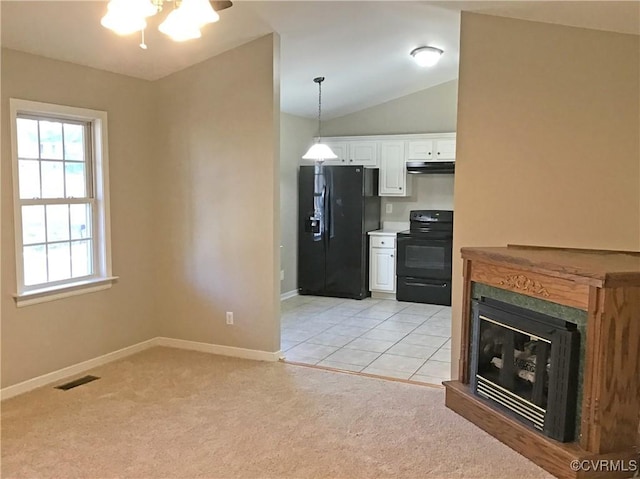 kitchen with pendant lighting, light colored carpet, white cabinetry, and black appliances