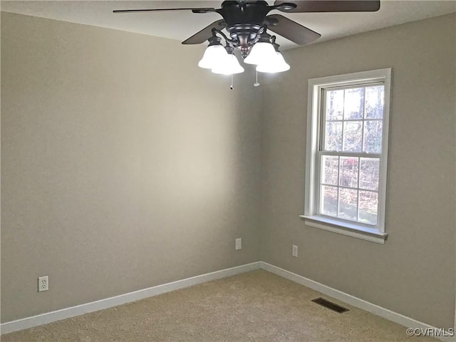 carpeted spare room with ceiling fan