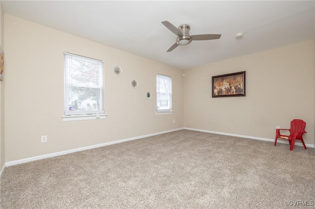 empty room with ceiling fan and carpet flooring