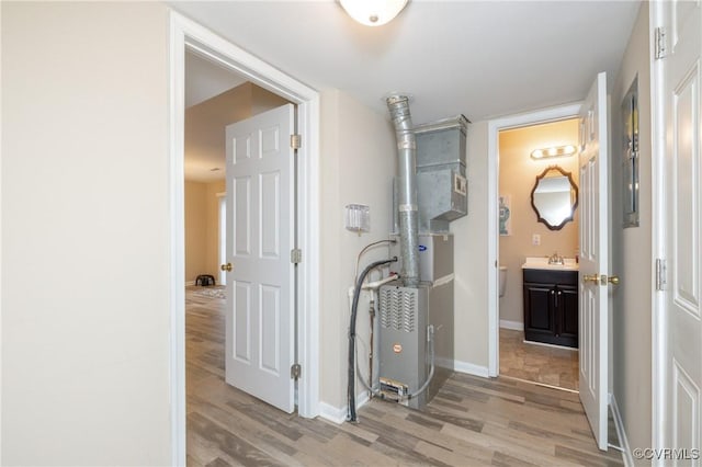 hallway with light hardwood / wood-style floors