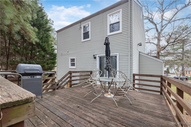 wooden terrace featuring a grill