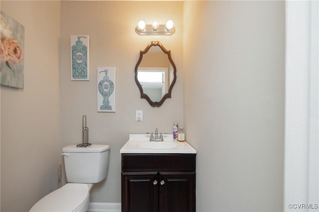 bathroom featuring toilet and vanity