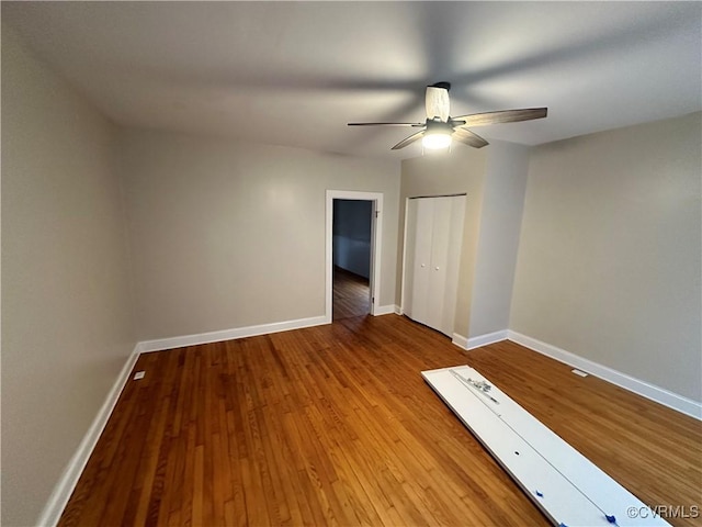 unfurnished bedroom with ceiling fan, light hardwood / wood-style flooring, and a closet