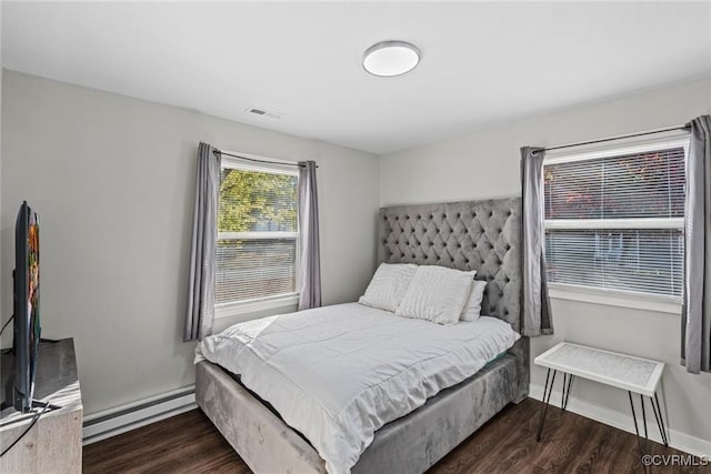 bedroom featuring dark wood-type flooring and baseboard heating