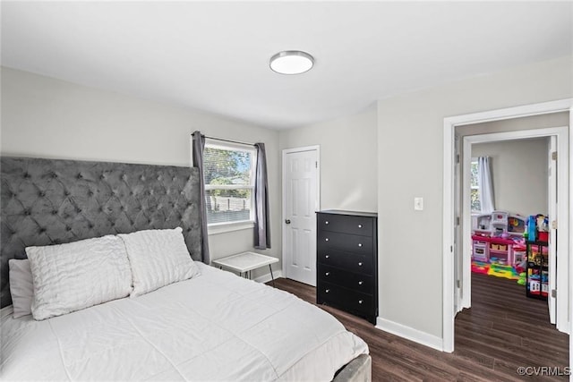 bedroom with dark wood-type flooring