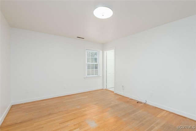 spare room with light hardwood / wood-style flooring