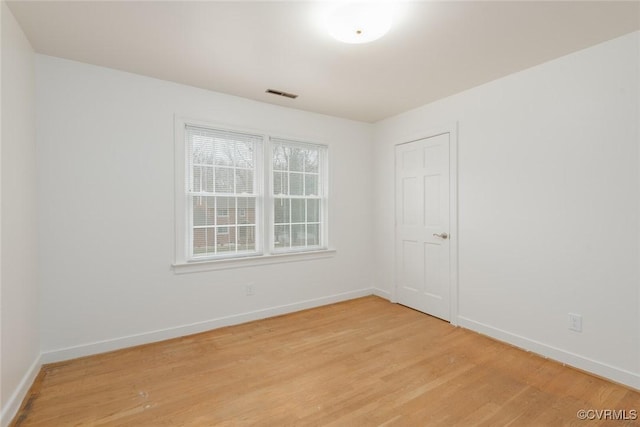 spare room featuring light wood-type flooring