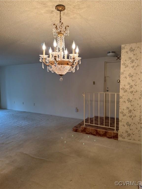 interior space with a textured ceiling and a chandelier