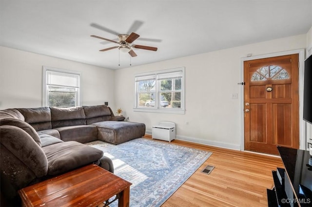 living room with ceiling fan, a healthy amount of sunlight, and light hardwood / wood-style floors