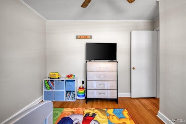 game room featuring ceiling fan, crown molding, and wood-type flooring