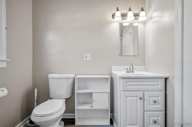 bathroom featuring toilet and vanity