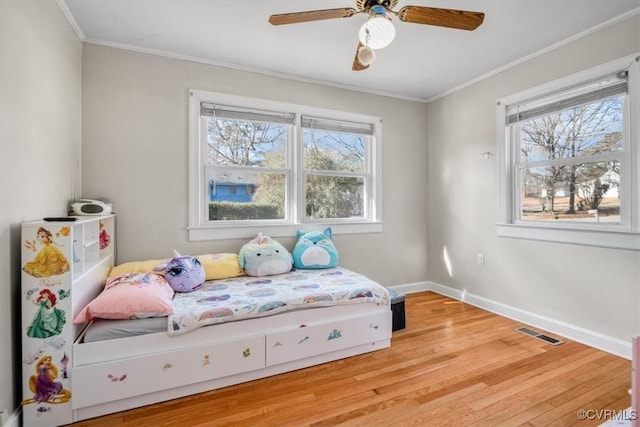 sitting room featuring a wealth of natural light, light hardwood / wood-style flooring, and crown molding