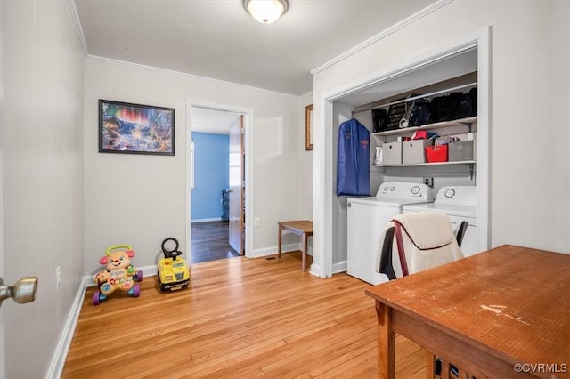 clothes washing area featuring separate washer and dryer, ornamental molding, and light wood-type flooring