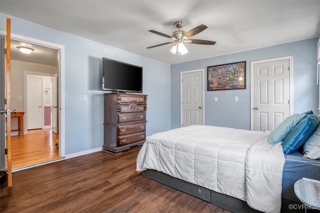 bedroom with ceiling fan and dark wood-type flooring