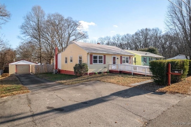 single story home featuring central air condition unit, a deck, an outdoor structure, and a garage