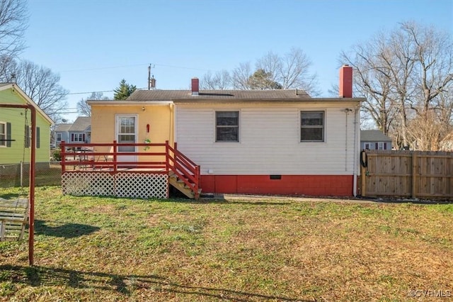 view of front of property featuring a front lawn and a deck