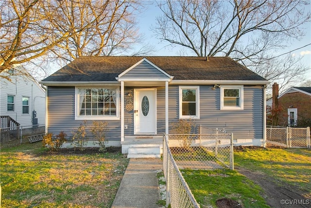 bungalow-style home with a front lawn