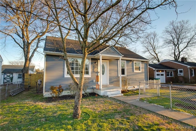 bungalow with an outbuilding, a garage, and a front yard