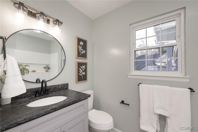 bathroom featuring toilet and vanity