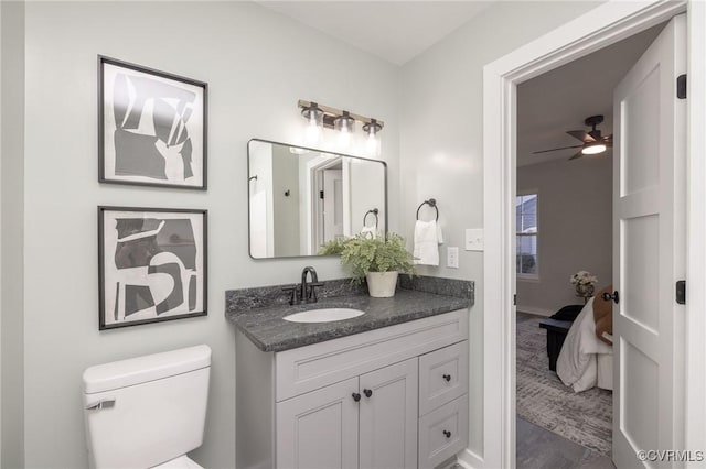 bathroom featuring toilet, vanity, ceiling fan, and hardwood / wood-style flooring