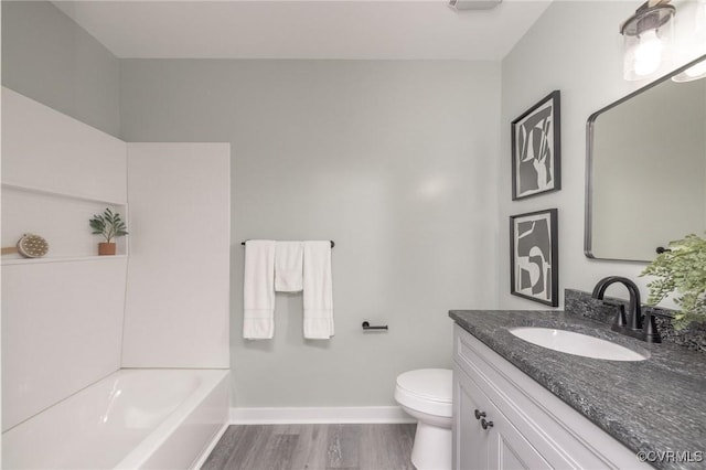 bathroom featuring toilet, vanity, and wood-type flooring