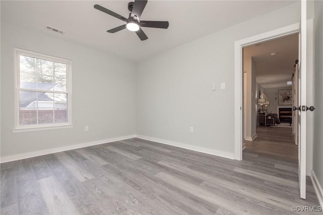 spare room featuring ceiling fan and light hardwood / wood-style floors