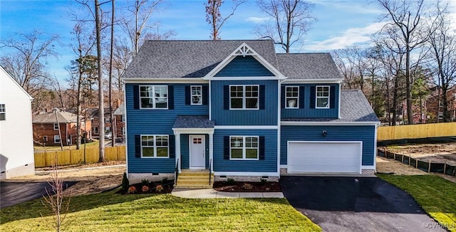 view of front of house with a garage and a front yard