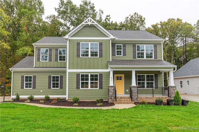 craftsman-style home featuring covered porch and a front lawn