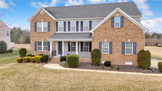 view of front property featuring covered porch and a front lawn