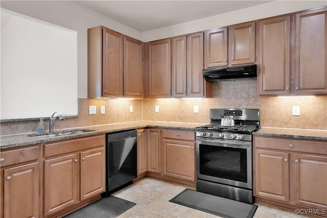 kitchen featuring stainless steel gas range oven, tasteful backsplash, dishwasher, light stone countertops, and sink