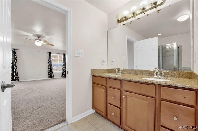 bathroom with ceiling fan, tile patterned floors, an enclosed shower, and vanity