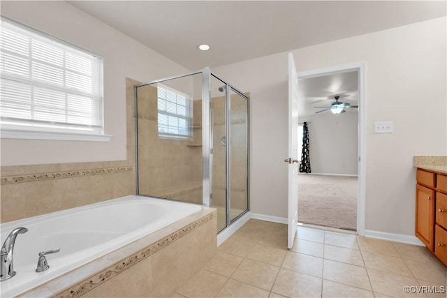 bathroom featuring tile patterned flooring, separate shower and tub, and vanity