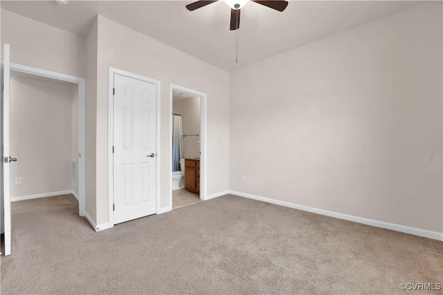 unfurnished bedroom with light carpet, ceiling fan, and ensuite bath