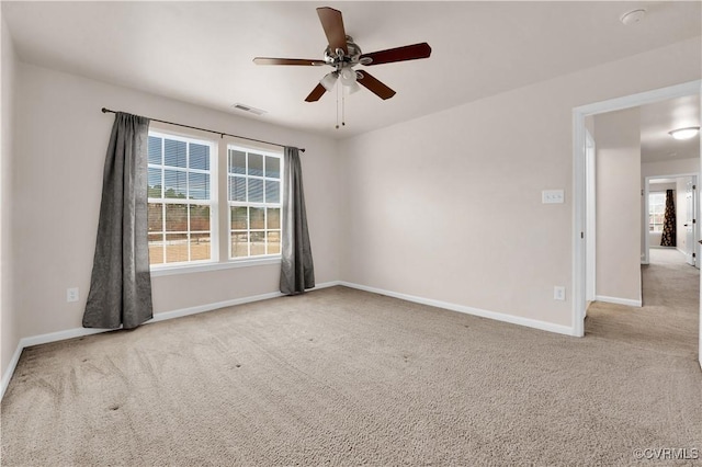 unfurnished room with ceiling fan and light colored carpet