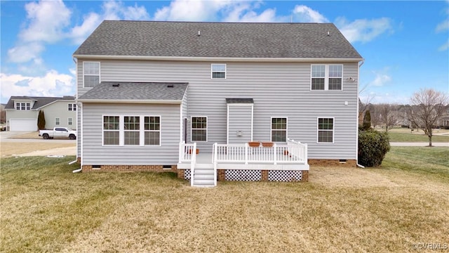 rear view of house with a yard and a wooden deck