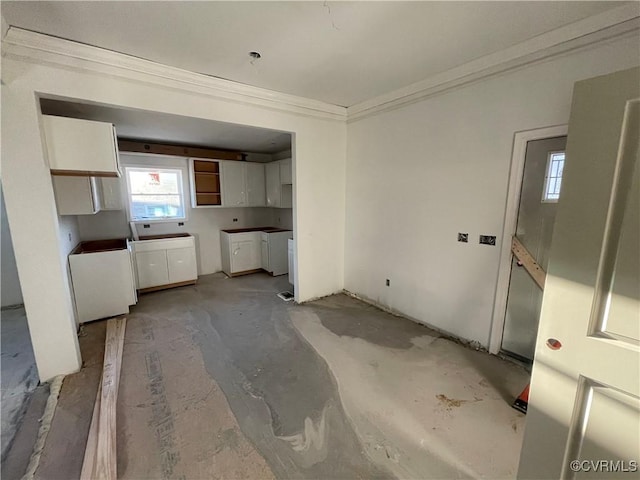 kitchen featuring crown molding and white cabinetry