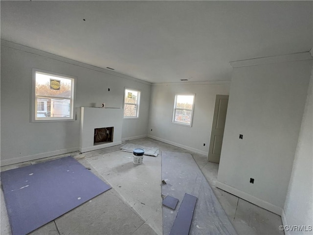 unfurnished living room featuring crown molding and a fireplace