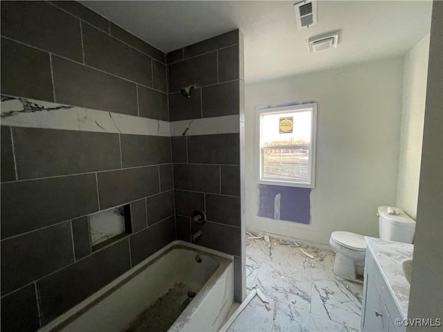 full bathroom featuring toilet, tiled shower / bath, and vanity