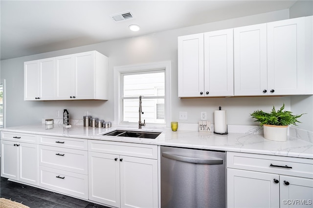 kitchen featuring dark wood-type flooring, white cabinetry, sink, light stone counters, and stainless steel dishwasher