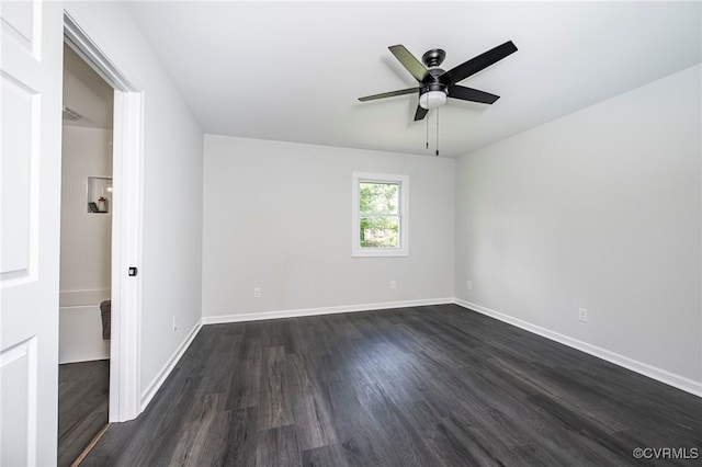 spare room featuring ceiling fan and dark hardwood / wood-style floors