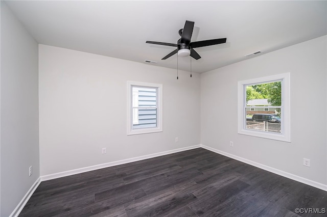 spare room with ceiling fan and dark wood-type flooring