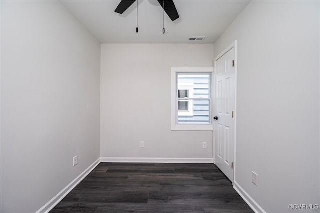 empty room featuring ceiling fan and dark hardwood / wood-style flooring