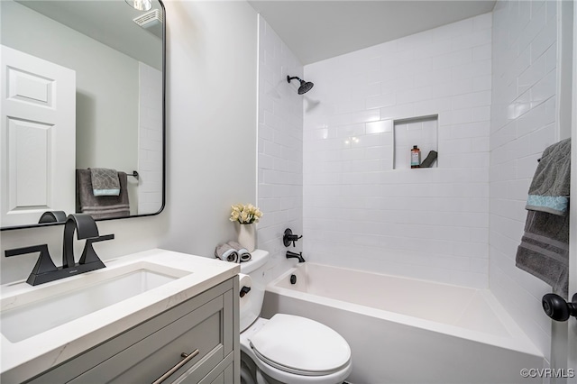 full bathroom with toilet, vanity, and tiled shower / bath combo