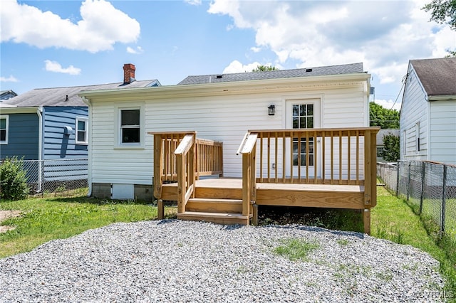 back of house featuring a deck and a yard