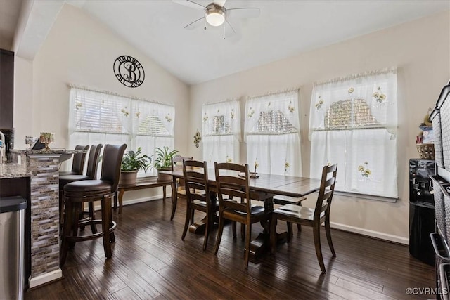 dining area with ceiling fan, dark hardwood / wood-style floors, vaulted ceiling, and a wealth of natural light