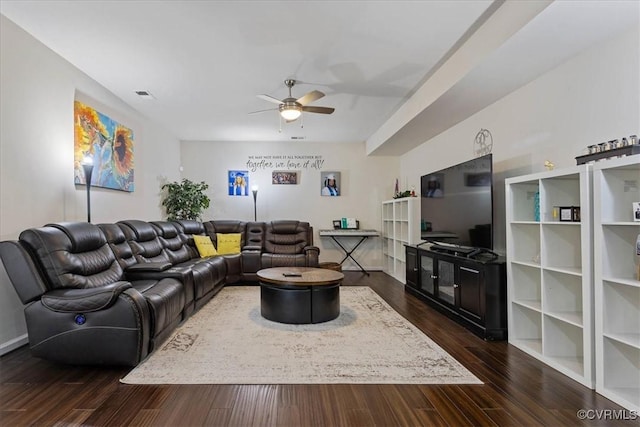 living room featuring ceiling fan and dark hardwood / wood-style flooring