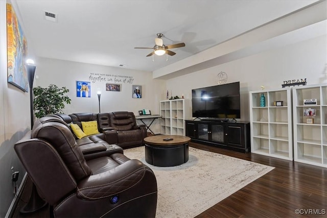 living room with dark wood-type flooring and ceiling fan