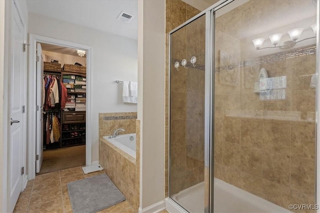 bathroom with tile patterned floors and independent shower and bath